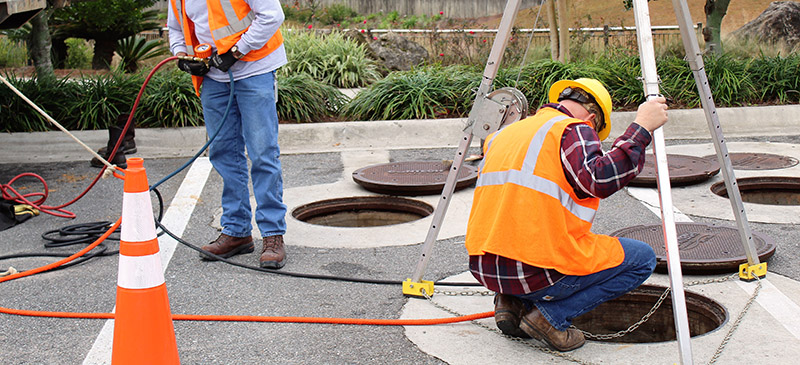 a crew works on an open sewer